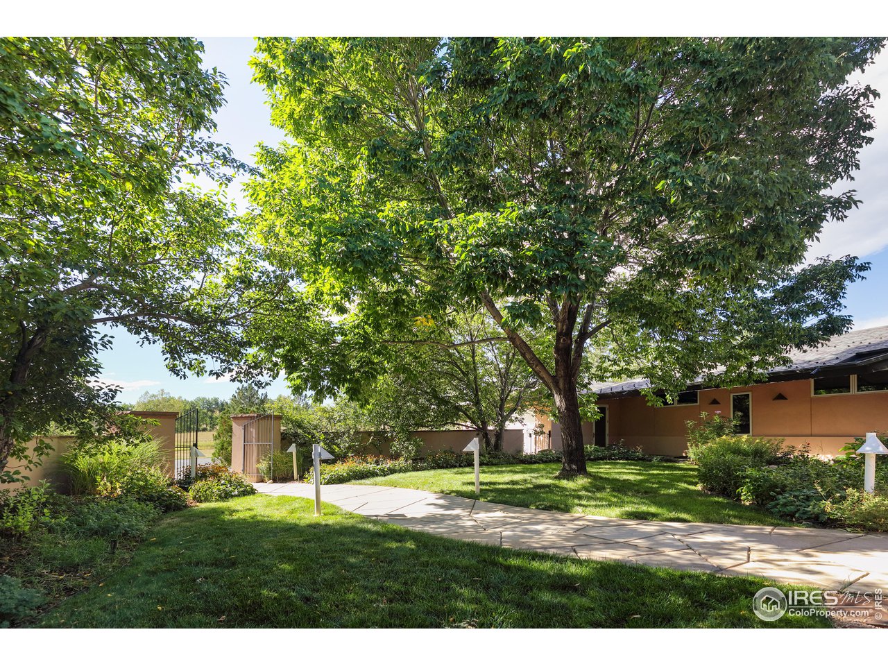 640 South 68th Street Boulder, CO 80303 - Photo 14 of 40 a backyard of a house with a garden and tree