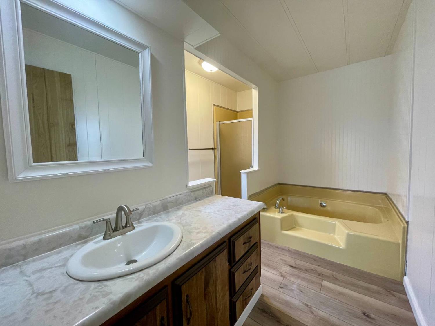 3901 Lake Road, Unit 111 West Sacramento, CA 95691 - Photo 6 of 16 a bathroom with a granite countertop sink and a bathtub