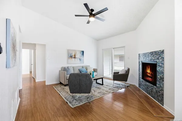 a living room with furniture and a fireplace