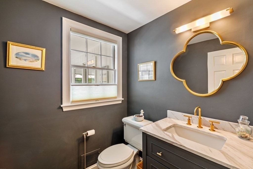 10 Sturbridge Road Wellesley, MA 02481 - Photo 19 of 34 a bathroom with a toilet a sink and mirror