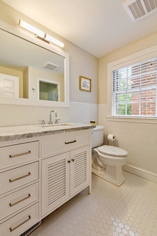 10 Sturbridge Road Wellesley, MA 02481 - Photo 21 of 34 a bathroom with a double vanity sink a mirror and a bathtub