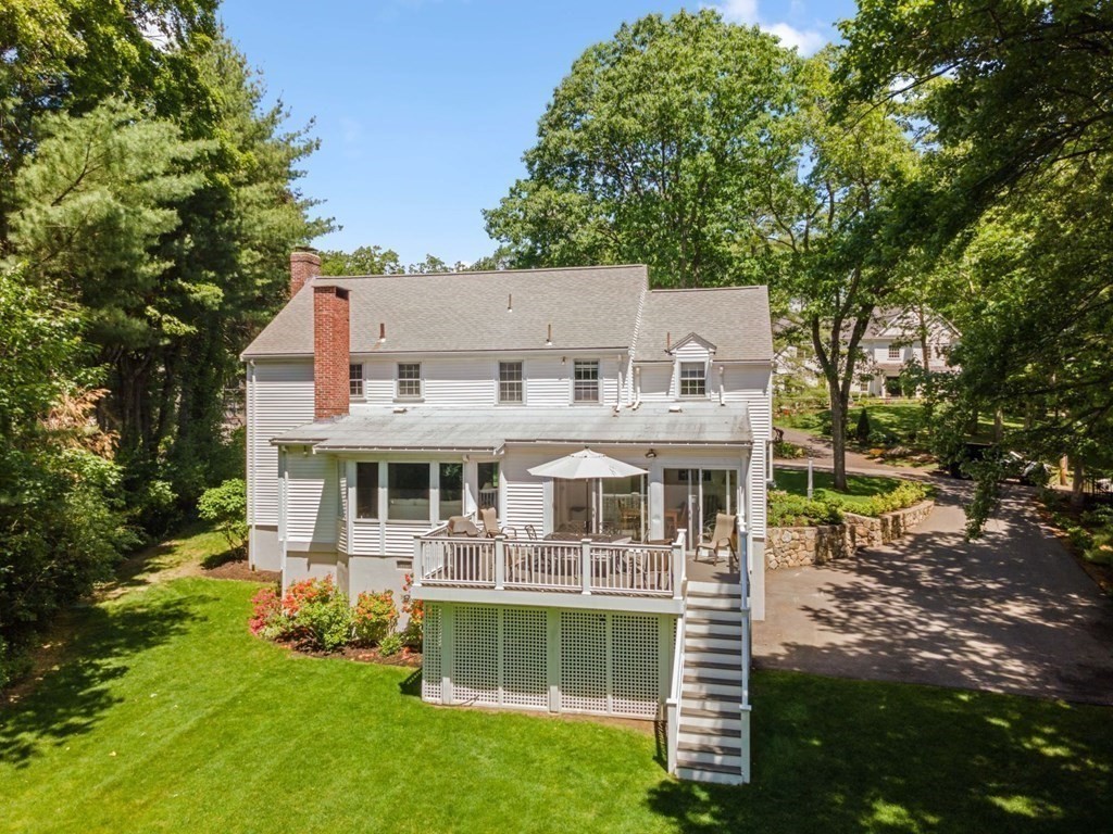 10 Sturbridge Road Wellesley, MA 02481 - Photo 28 of 34 a front view of a house with a yard table and chairs