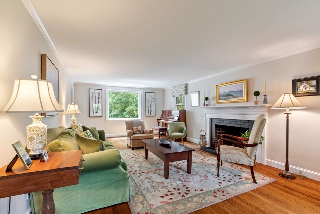 10 Sturbridge Road Wellesley, MA 02481 - Photo 5 of 34 a living room with furniture a fireplace and a table