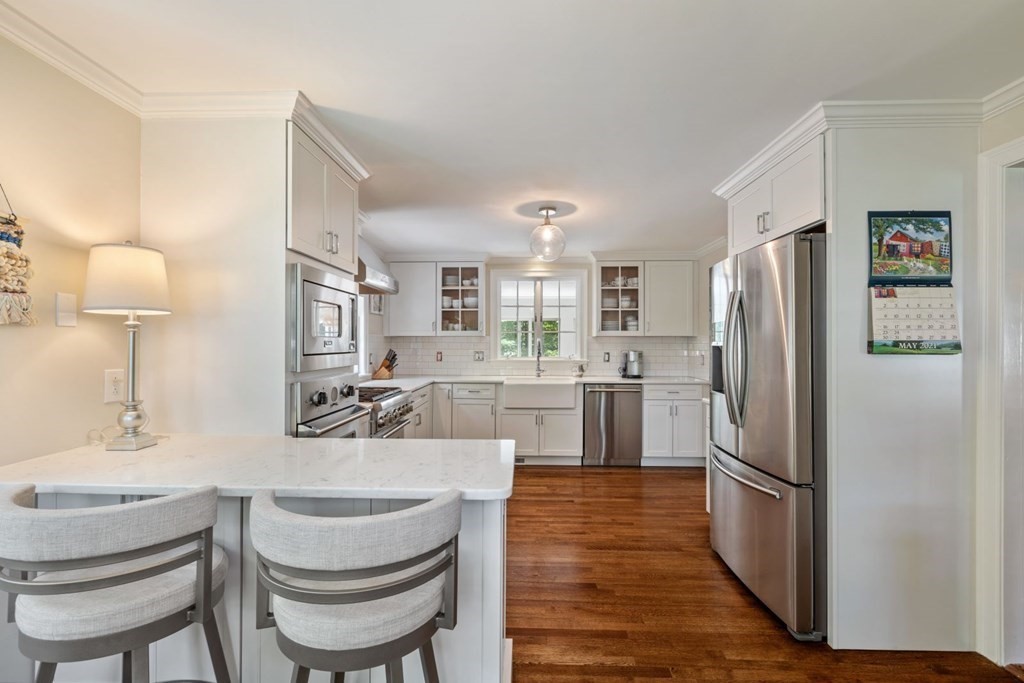 10 Sturbridge Road Wellesley, MA 02481 - Photo 10 of 34 a kitchen with a refrigerator a sink and chairs