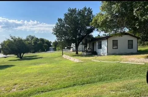 a view of a house with a backyard