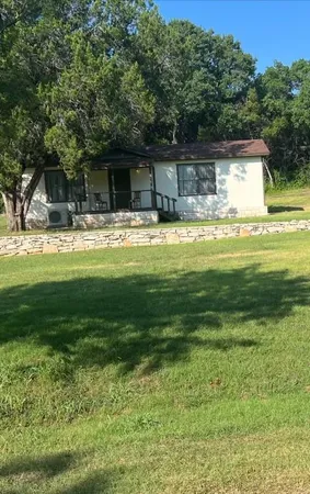 a front view of house with yard and green space