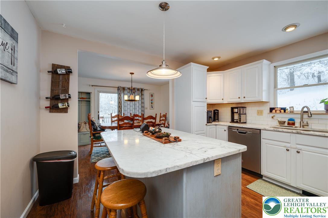 6838 Lime Kiln Road Slatington, PA 18080 - Photo 23 of 60 a kitchen with stainless steel appliances a dining table chairs and a refrigerator