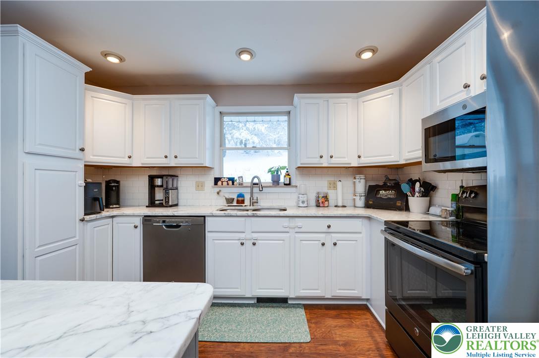 6838 Lime Kiln Road Slatington, PA 18080 - Photo 24 of 60 a kitchen with stainless steel appliances granite countertop a stove a sink dishwasher and a refrigerator