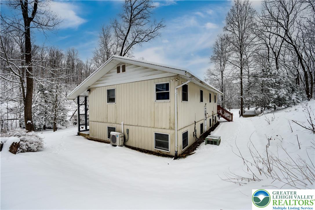 6838 Lime Kiln Road Slatington, PA 18080 - Photo 48 of 60 a view of a white house with a yard covered in snow