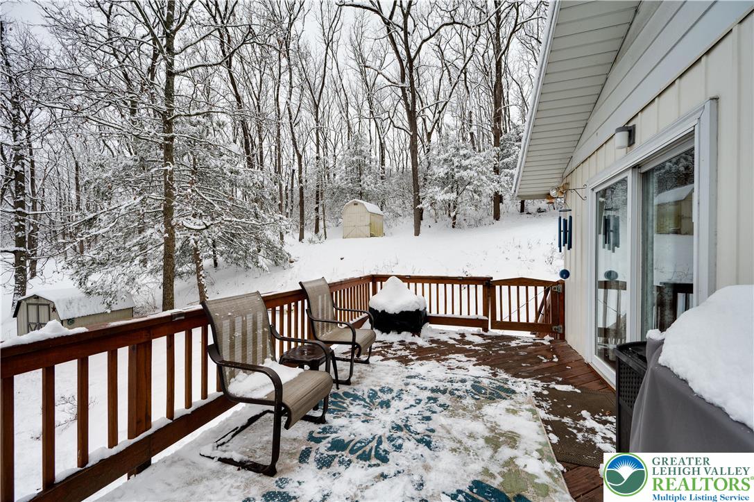 6838 Lime Kiln Road Slatington, PA 18080 - Photo 52 of 60 a view of a wooden deck with chairs and large trees