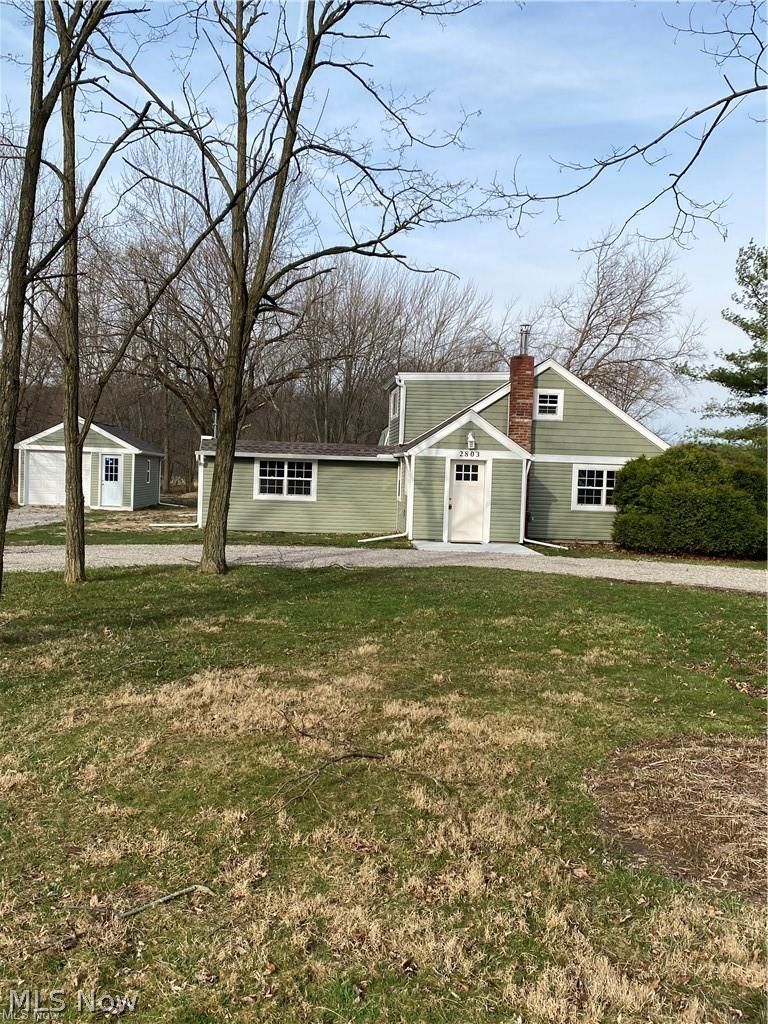 Front view of house and garage.  Large front yard