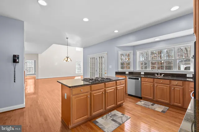 a spacious bedroom with a large bed and a potted plant