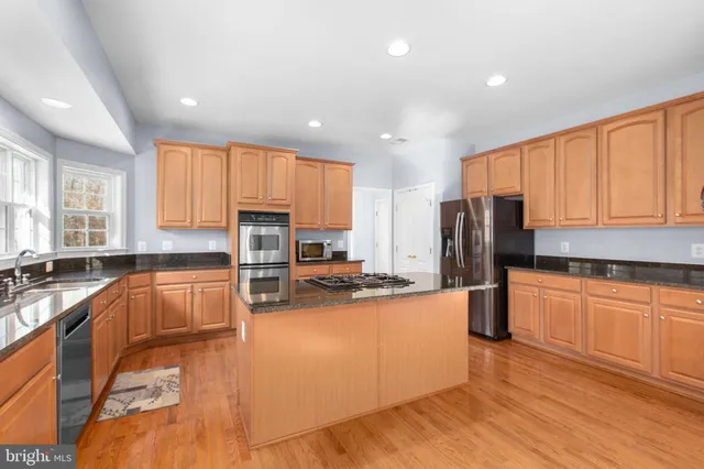 a spacious bathroom with a sink mirror and a bathtub
