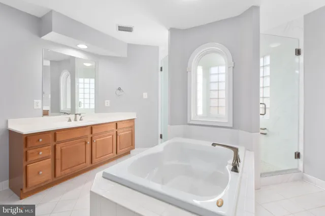 a kitchen with stainless steel appliances granite countertop a refrigerator a sink and a stove