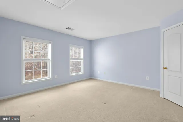 a view of a brick house with a small yard