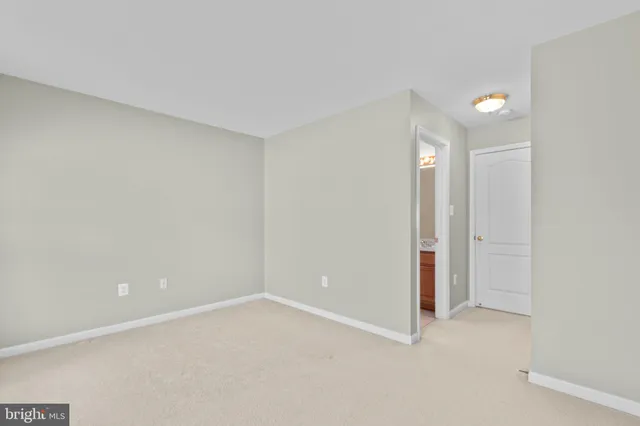 a view of a house with a small yard and wooden fence