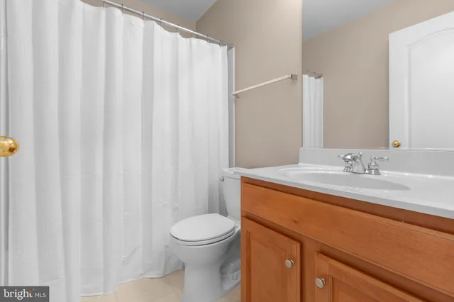 a view of a wooden house with large trees