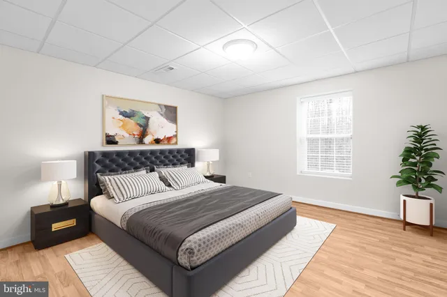 a view of an empty room with windows and chandelier fan