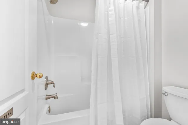 a front view of residential houses with yard and trees