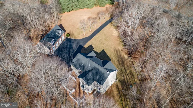 a kitchen with stainless steel appliances granite countertop a refrigerator a stove and a sink with wooden floor