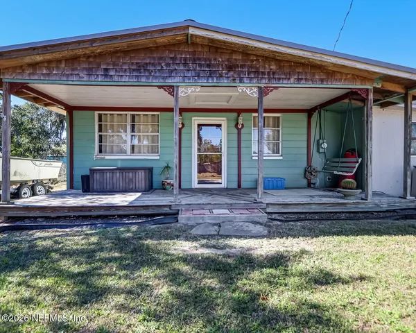 a view of a house with a wooden deck