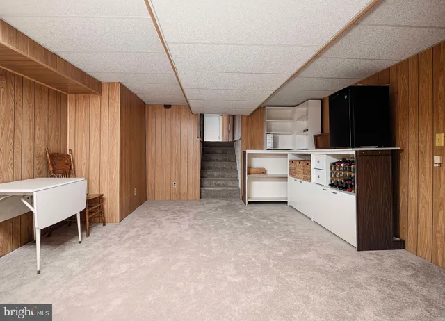 a view of kitchen with refrigerator and window
