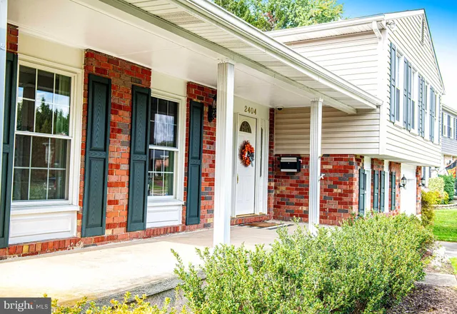 a front view of a building with a garden