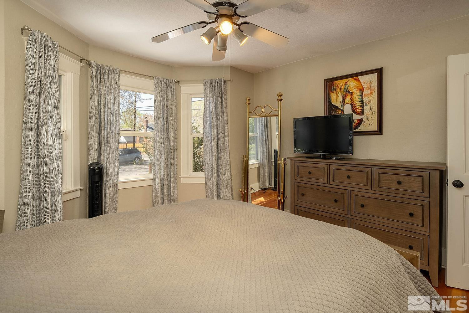 207 Martin Street Reno, NV 89509 - Photo 13 of 40 a bedroom with a bed and a flat screen tv