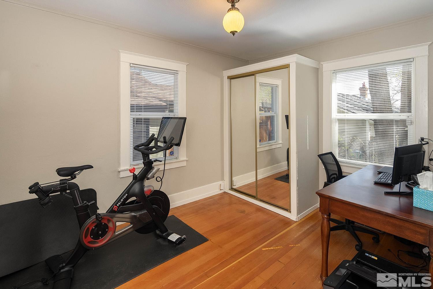 207 Martin Street Reno, NV 89509 - Photo 14 of 40 a view of workspace with wooden floor windows gym equipment and view