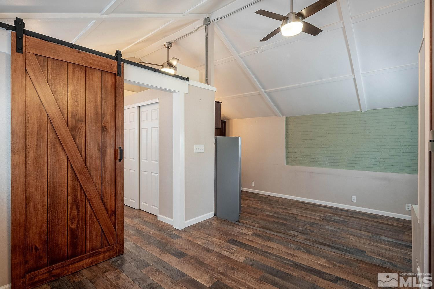 207 Martin Street Reno, NV 89509 - Photo 25 of 40 an empty room with wooden floor staircase and windows