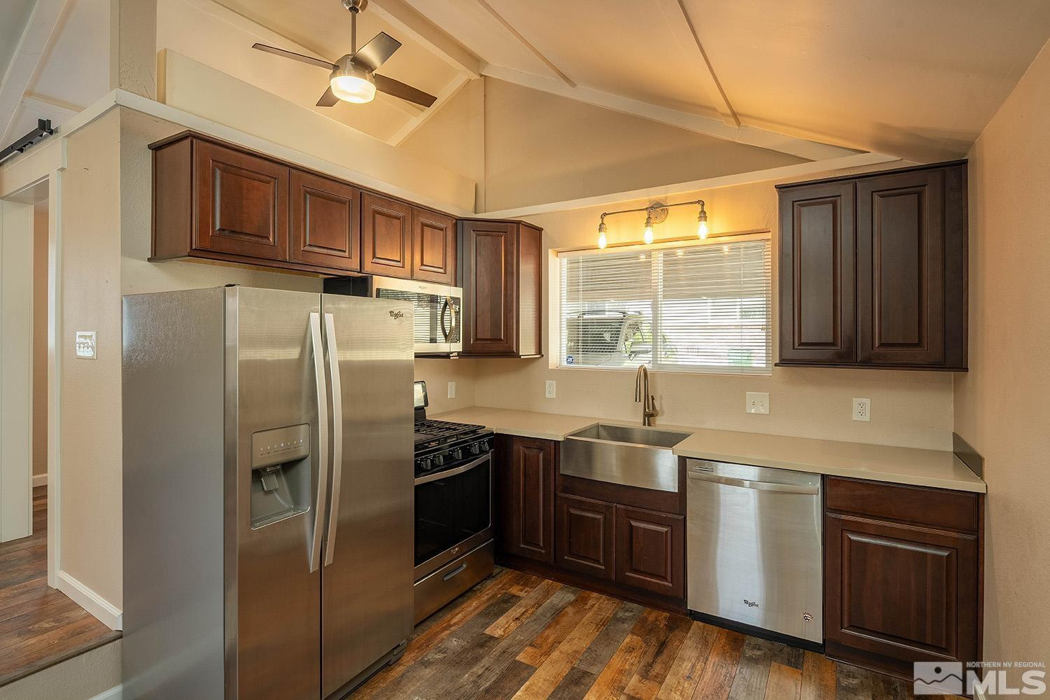 207 Martin Street Reno, NV 89509 - Photo 28 of 40 a kitchen with stainless steel appliances granite countertop a refrigerator a sink dishwasher a stove and white countertops with wooden floor