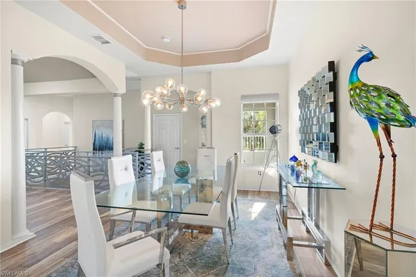 a view of a dining room with furniture and chandelier