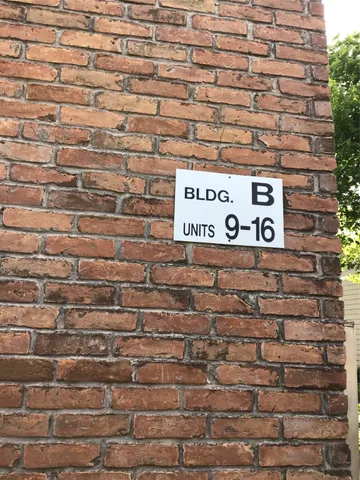 a close up of a sign on a brick wall