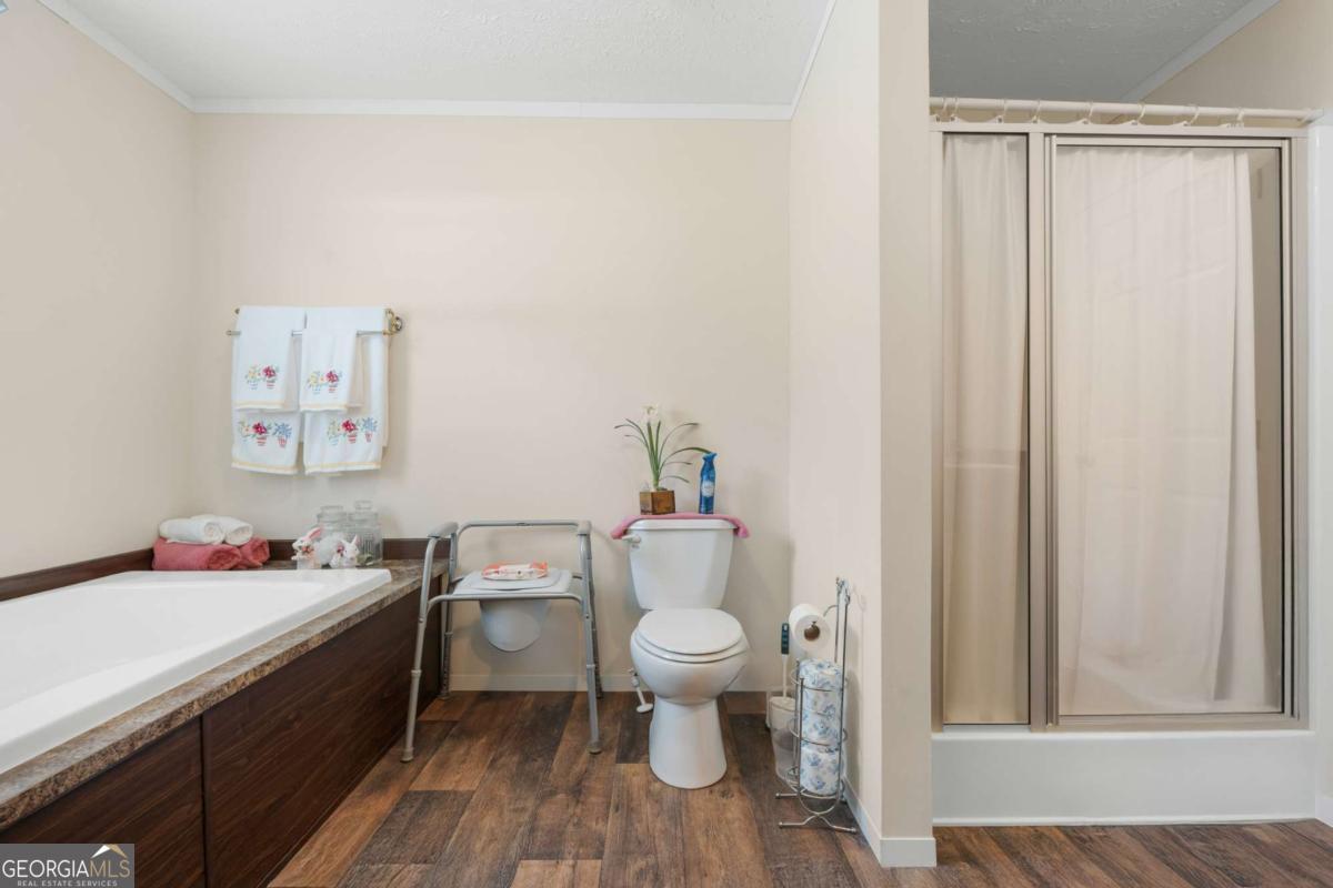 3516 Bennetts Landing Road Millen, GA 30442 - Photo 18 of 34 a bathroom with a toilet a sink and a window