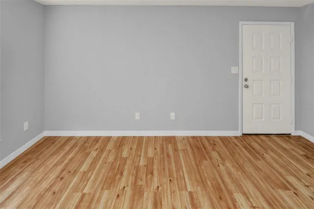 a view of room with wooden floor and fan
