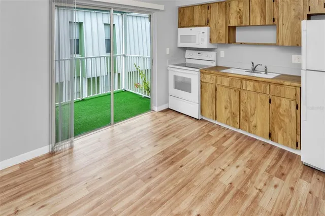 a kitchen with a wooden floor and a sink