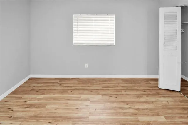 a view of a room with wooden floor and white walls