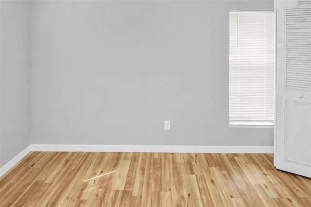 a view of a room with wooden floor and window
