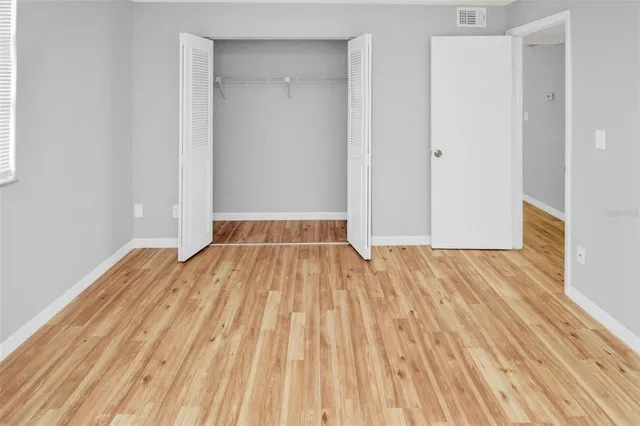 a view of a room with wooden floor and white walls