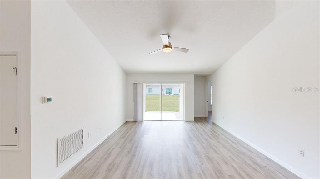 6089 Deer Run Road North Port, FL 34291 - Photo 2 of 10 a view of an empty room with wooden floor and a window
