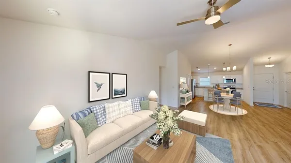 a living room with furniture and a wooden floor