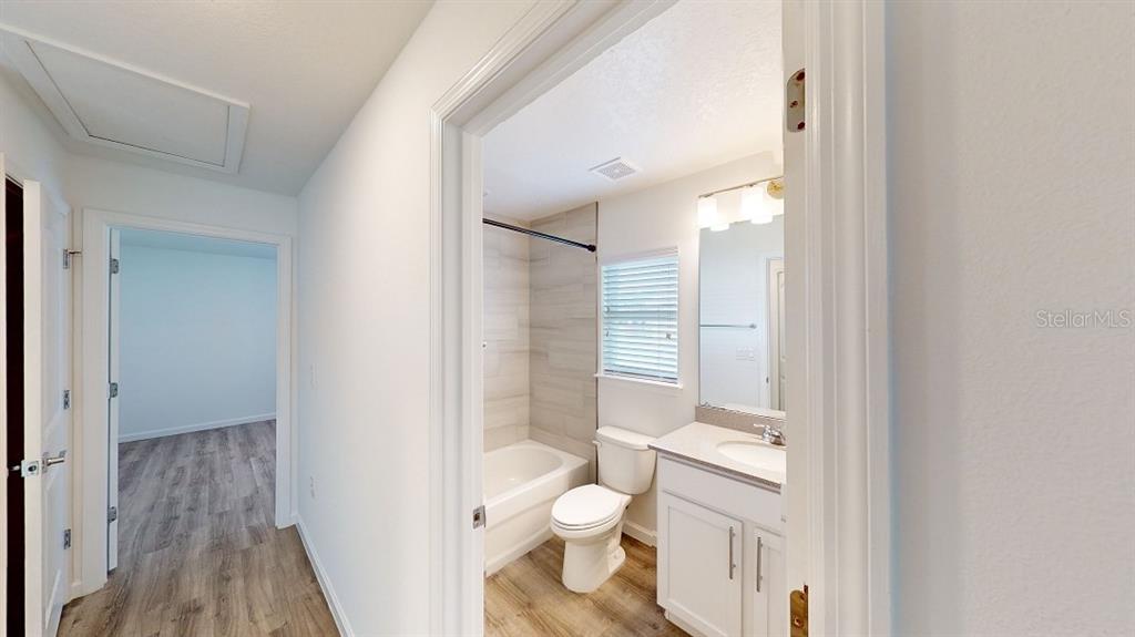6089 Deer Run Road North Port, FL 34291 - Photo 9 of 10 a bathroom with a granite countertop toilet a sink and a mirror