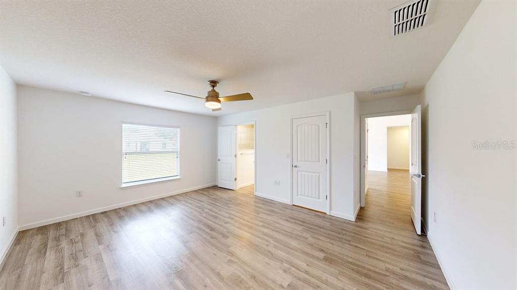 6089 Deer Run Road North Port, FL 34291 - Photo 10 of 10 a view of an empty room with wooden floor and a window