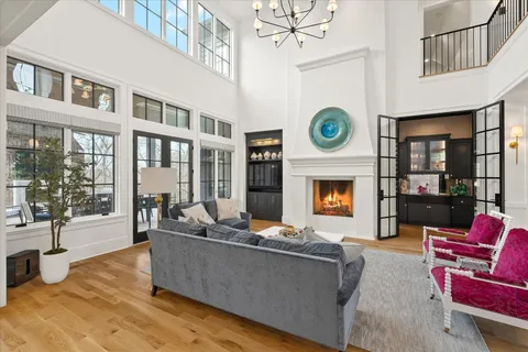 a living room with furniture a flat screen tv and a floor to ceiling window