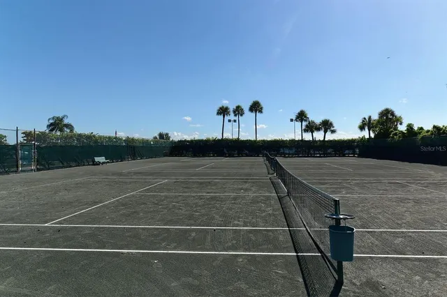 a view of water with boats and trees in the background