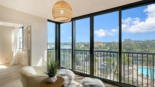 a living room filled with furniture and a potted plant