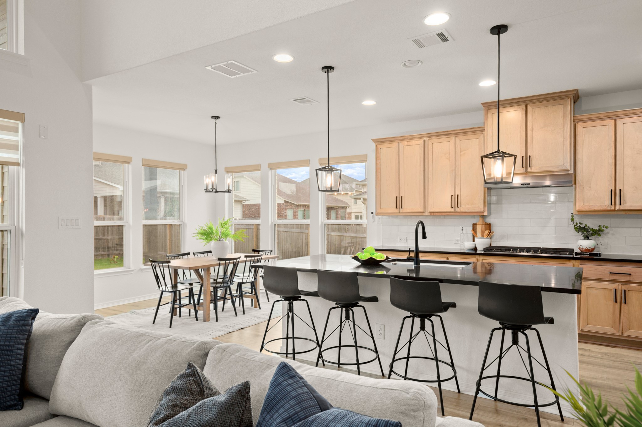 20521 Martin Lane Pflugerville, TX 78660 - Photo 9 of 40 The kitchen boasts a large center island lined with bar seating, along with sleek black quartz countertops and black fixtures, SS appliances, and more!