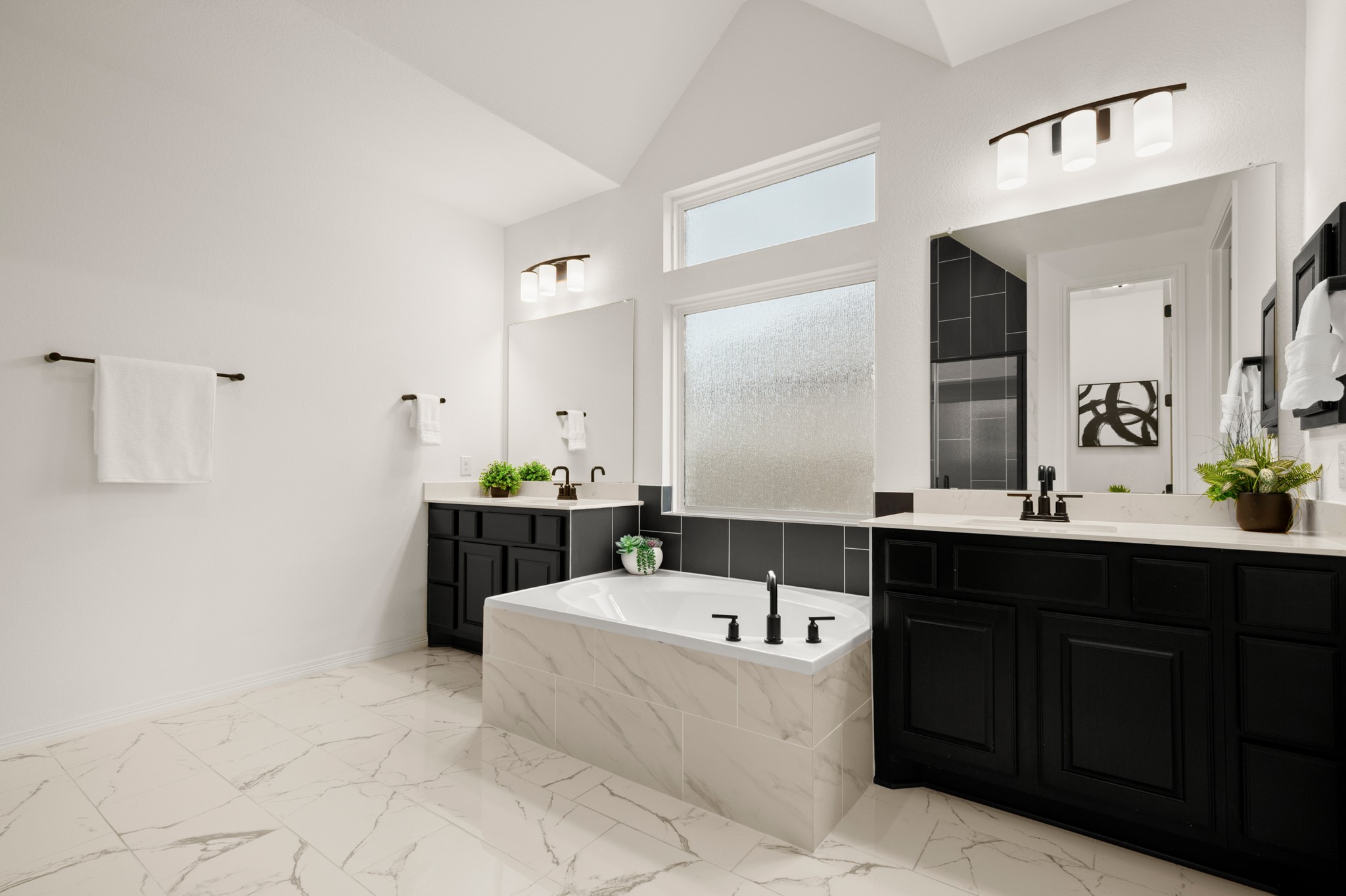 20521 Martin Lane Pflugerville, TX 78660 - Photo 9 of 40 The primary ensuite bath is your daily spa getaway complete with spacious separate vanities flanking a relaxing built-in soaking tub and refined modern finishes.