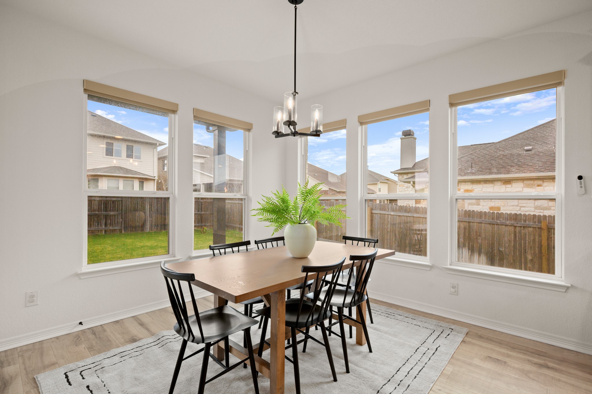 20521 Martin Lane Pflugerville, TX 78660 - Photo 11 of 40 The kitchen's sunny dining area is nestled in generous corner windows and offers ample space for a sizable dining table.