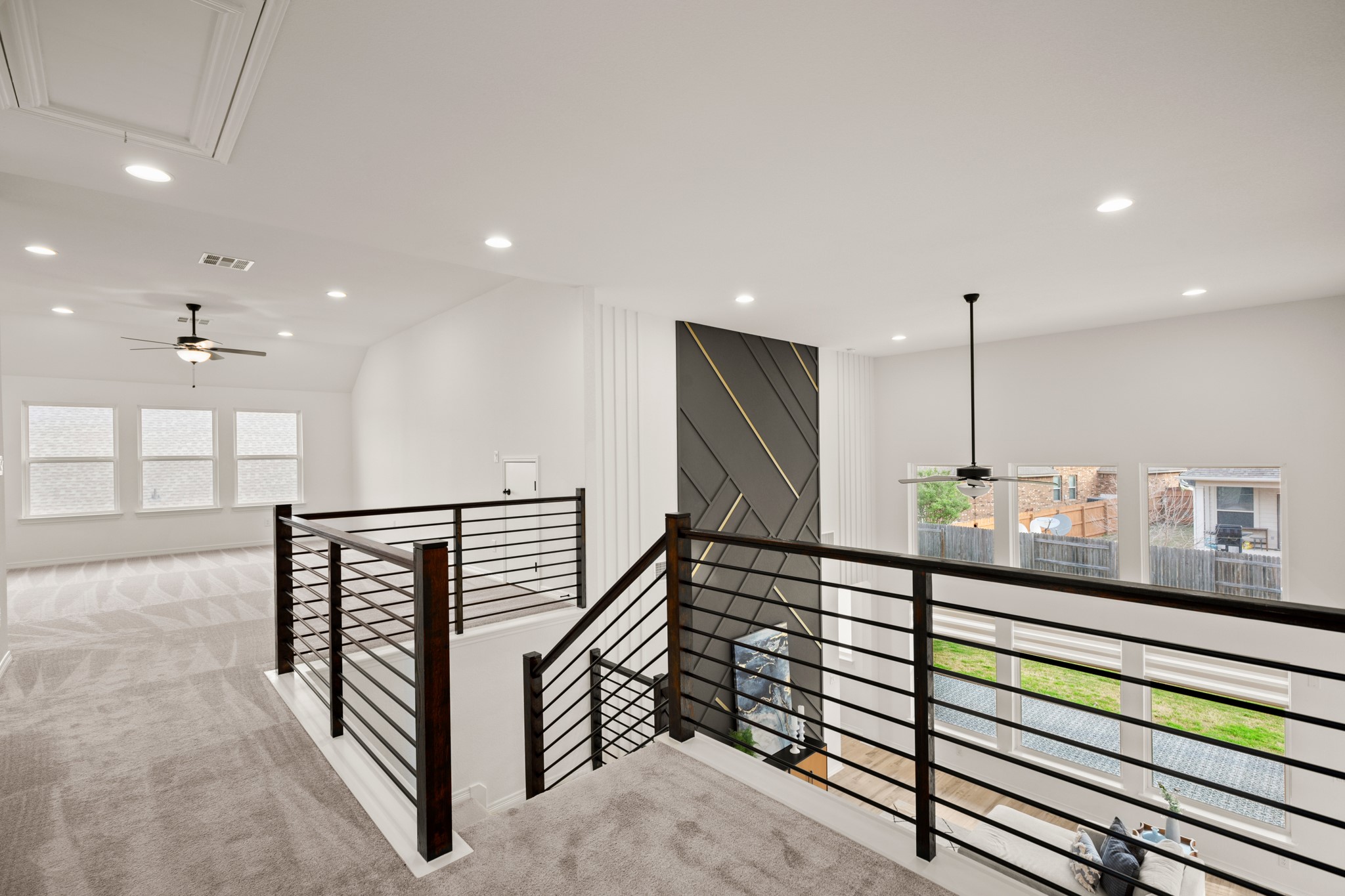 20521 Martin Lane Pflugerville, TX 78660 - Photo 20 of 40 A horizontal black stair railing and designer accent walls add a clean, contemporary edge.